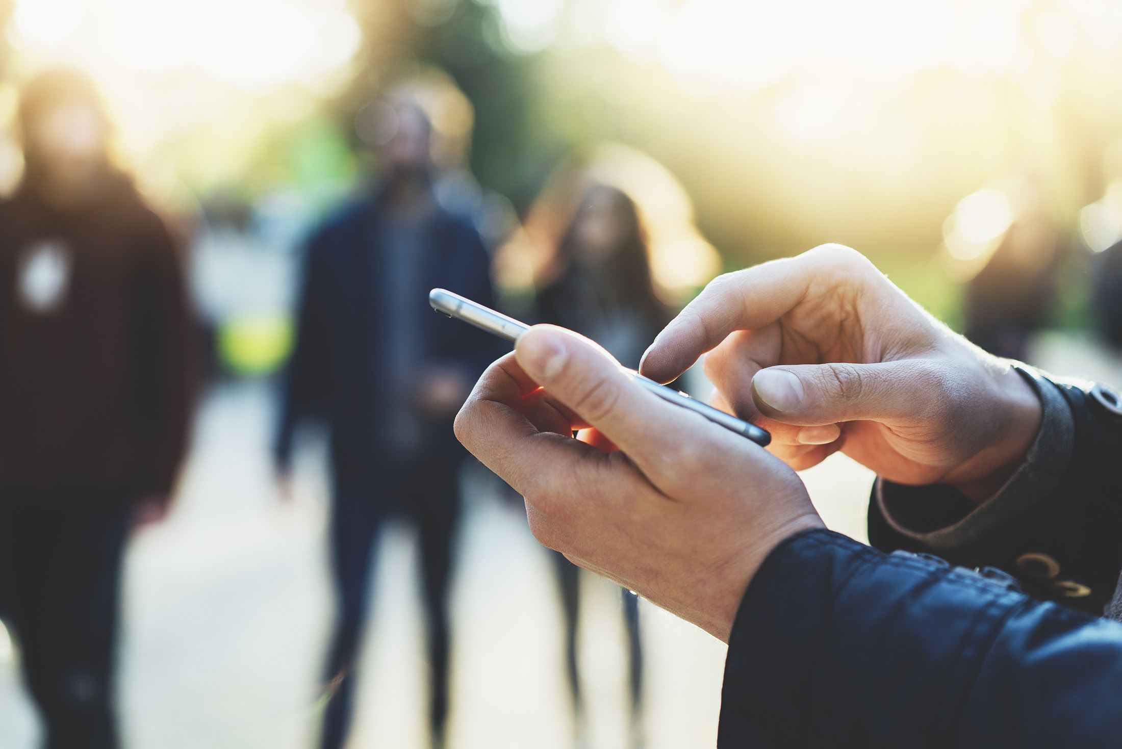 Man holding a phone in public